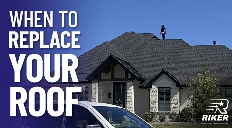 Front-facing view of a single-family home with a dark roof and a person standing on the roof under a clear blue sky, with large overlaid white text reading ‘WHEN TO REPLACE YOUR ROOF.’